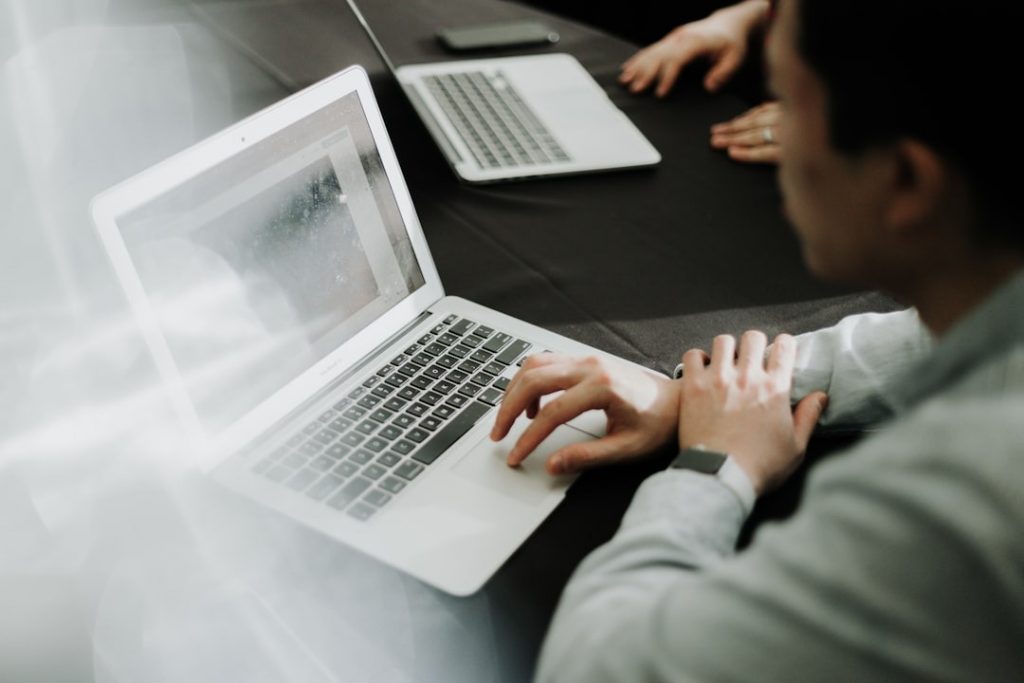 Business professional working on a laptop in 2025, researching sustainability and corporate ESG strategies